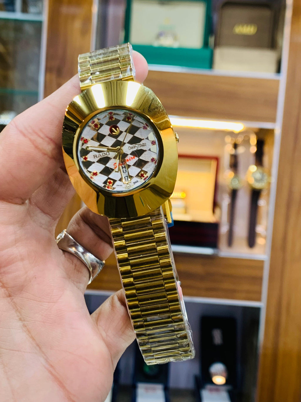 Rado DiaStar featuring a distinct oval case and a checkered dial pattern